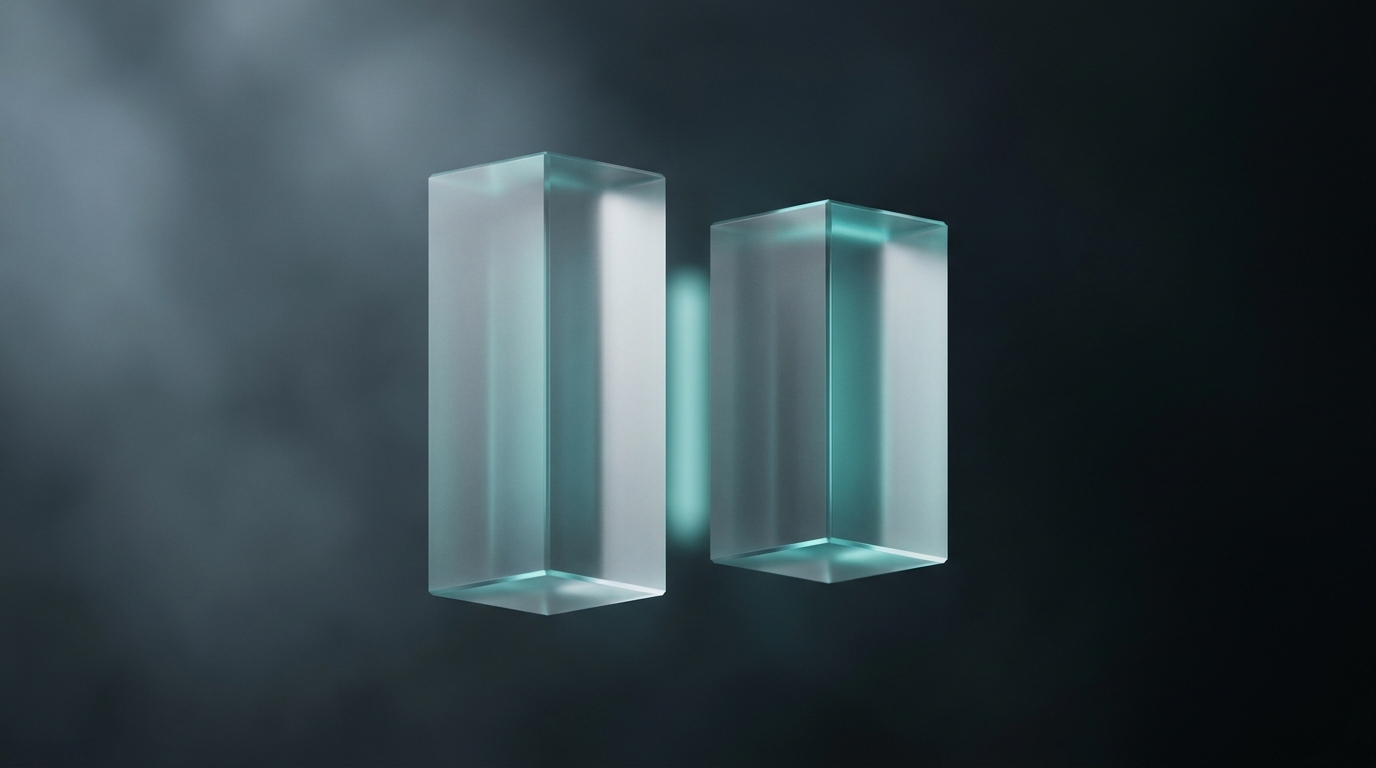 Two translucent geometric prisms suspended side by side on a dark slate background, lit from a single cool teal light source, with soft atmospheric depth behind them.